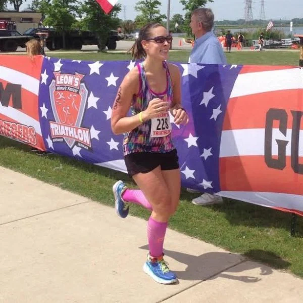 Kim crossing a finish line.